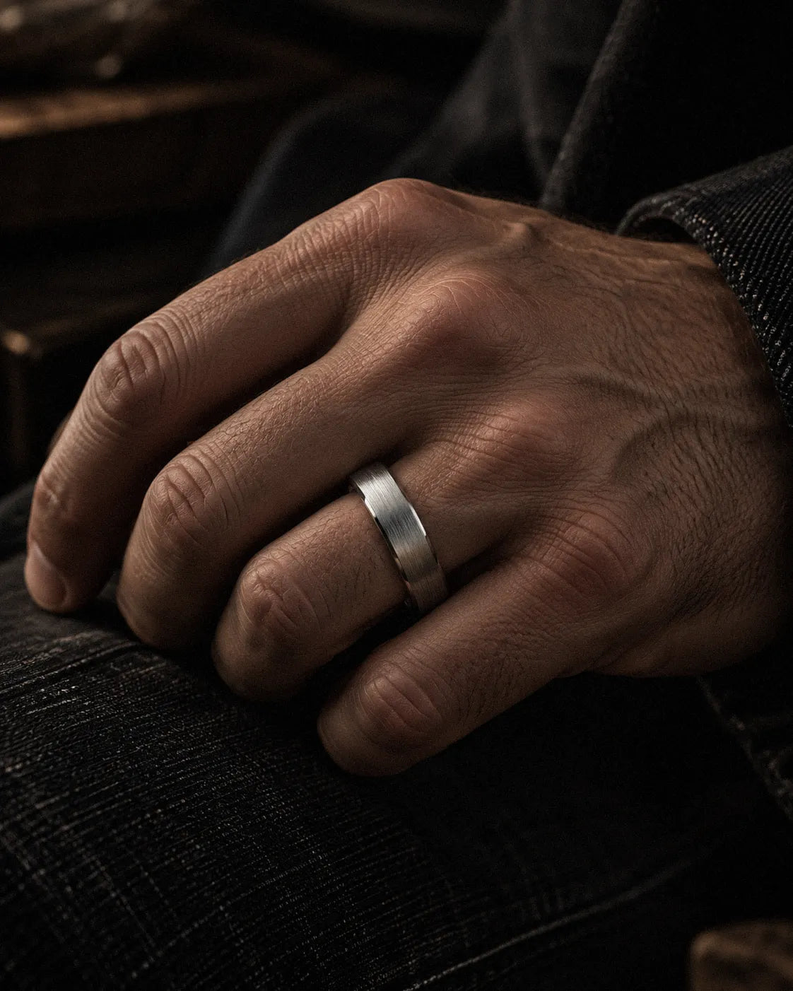 Man wearing a brushed silver tungsten wedding ring with antler inner sleeve