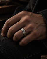 Man wearing a brushed silver tungsten wedding ring with antler inner sleeve