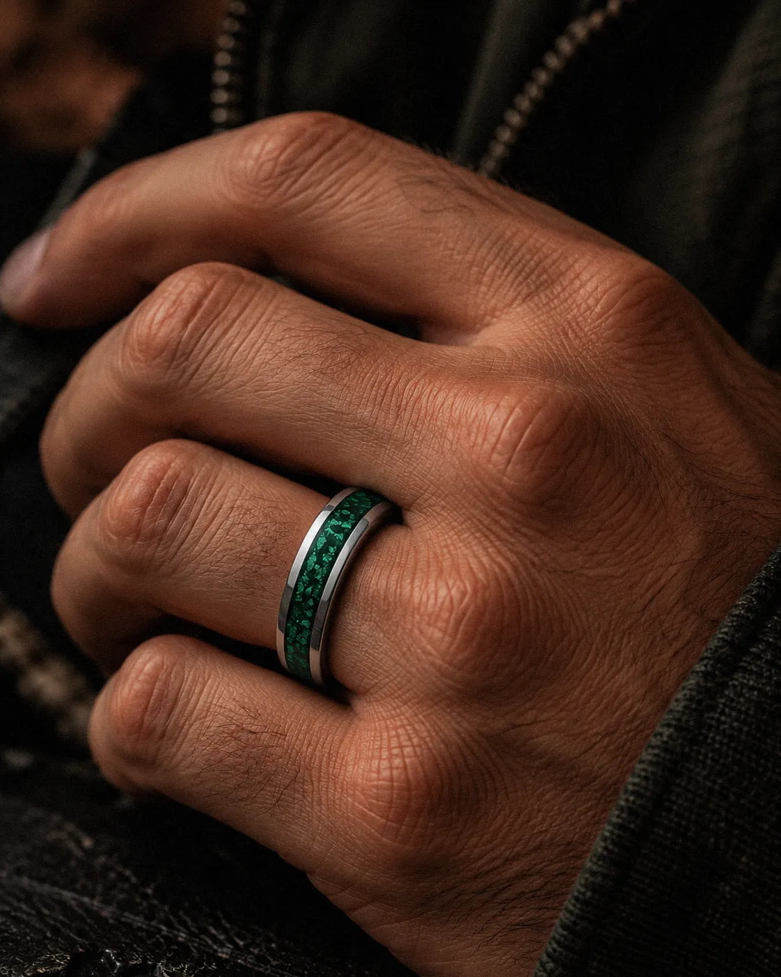 Man wearing a 6mm silver wedding ring with crushed emerald gemstone inlay