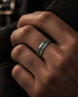 Man wearing a 6mm silver tungsten wedding ring with a natural green moss agate inlay.