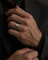 Man wearing a brushed silver tungsten wedding ring with natural antler inner sleeve