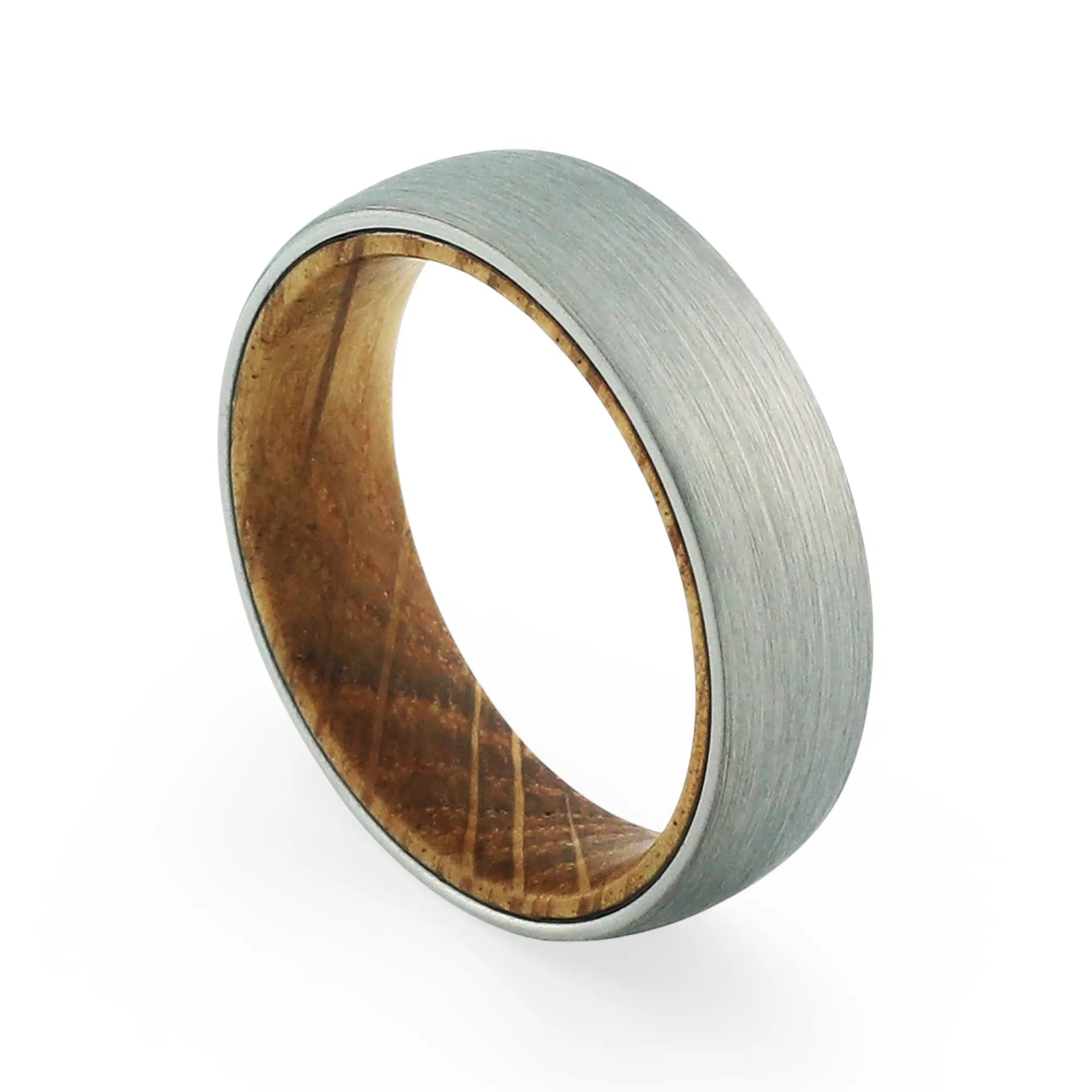 Angled view of a men's brushed tungsten wedding band with a real whiskey barrel wood inlay.
