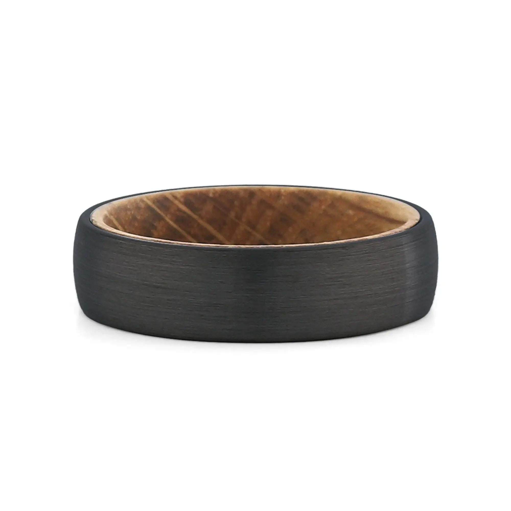 Top view of a men's black tungsten wedding band with a real whiskey barrel wood inlay.