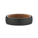 Top view of a men's black tungsten wedding band with a real whiskey barrel wood inlay.