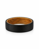 Top view of a men's black tungsten wedding band with a real whiskey barrel wood inlay.