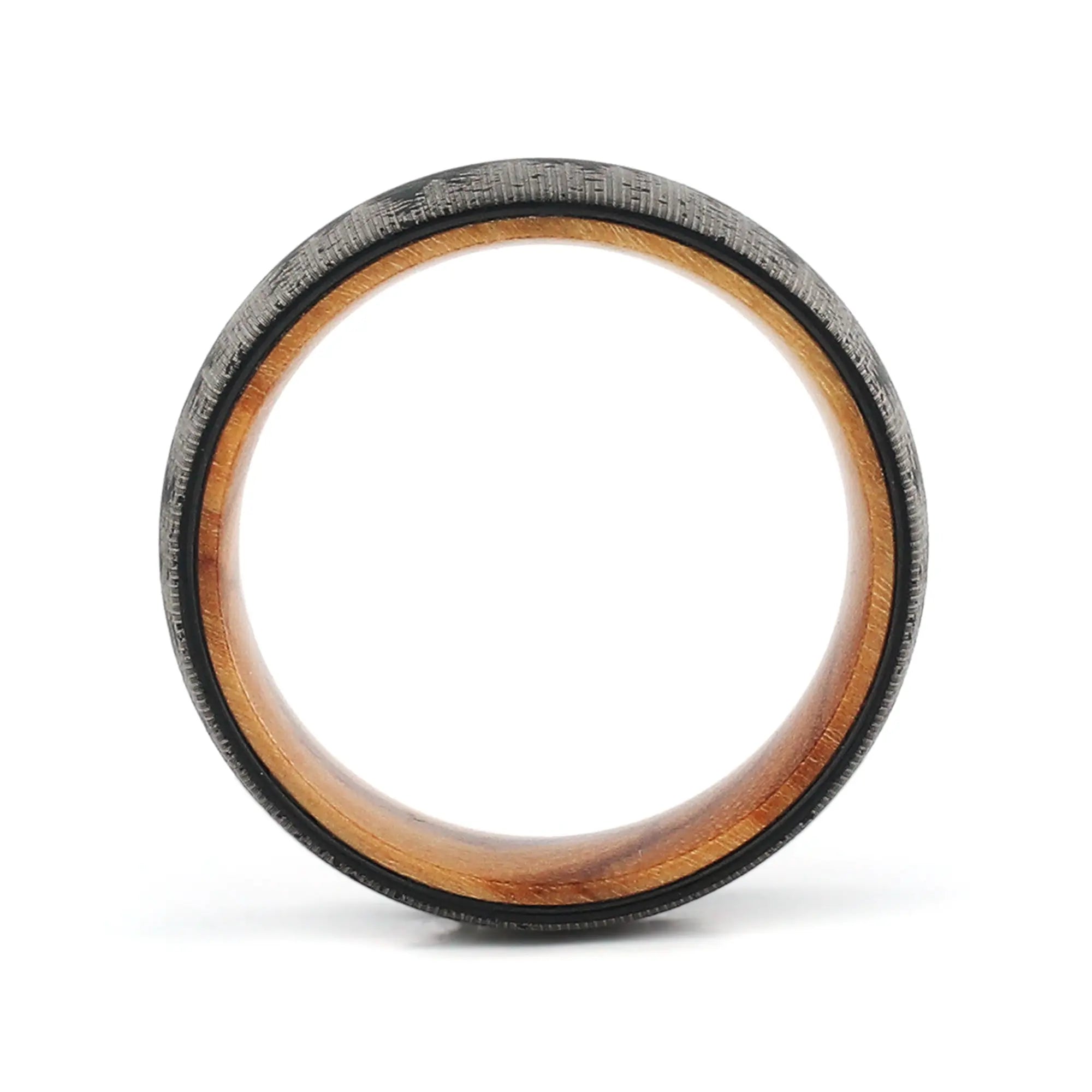 Side profile of an 8mm men's black tungsten wedding band with a forest engraving and real wood inlay.
