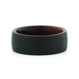 Top view of an 8mm men's black tungsten wedding band with a real rosewood inlay.