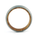 Side profile of a men's brushed tungsten wedding band with a real whiskey barrel wood inlay.