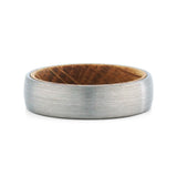 Top view of a men's brushed tungsten wedding band with a real whiskey barrel wood inlay.