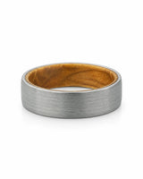 Top view of a men's brushed tungsten wedding band with a real whiskey barrel wood inlay.