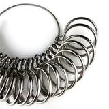 Close-up of metal ring sizer with engraved letter sizes