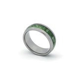 Close-up of moss agate inlay wedding band for men, shown on white backdrop