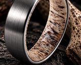Macro close up showing the natural antler interior of a tungsten wedding ring