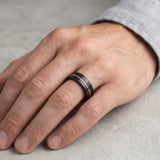 black and rose gold tungsten wedding ring on hand