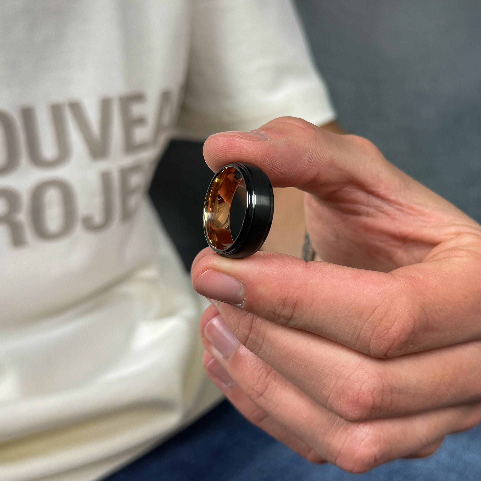 black brushed tungsten ring with a rose gold polished sleeve