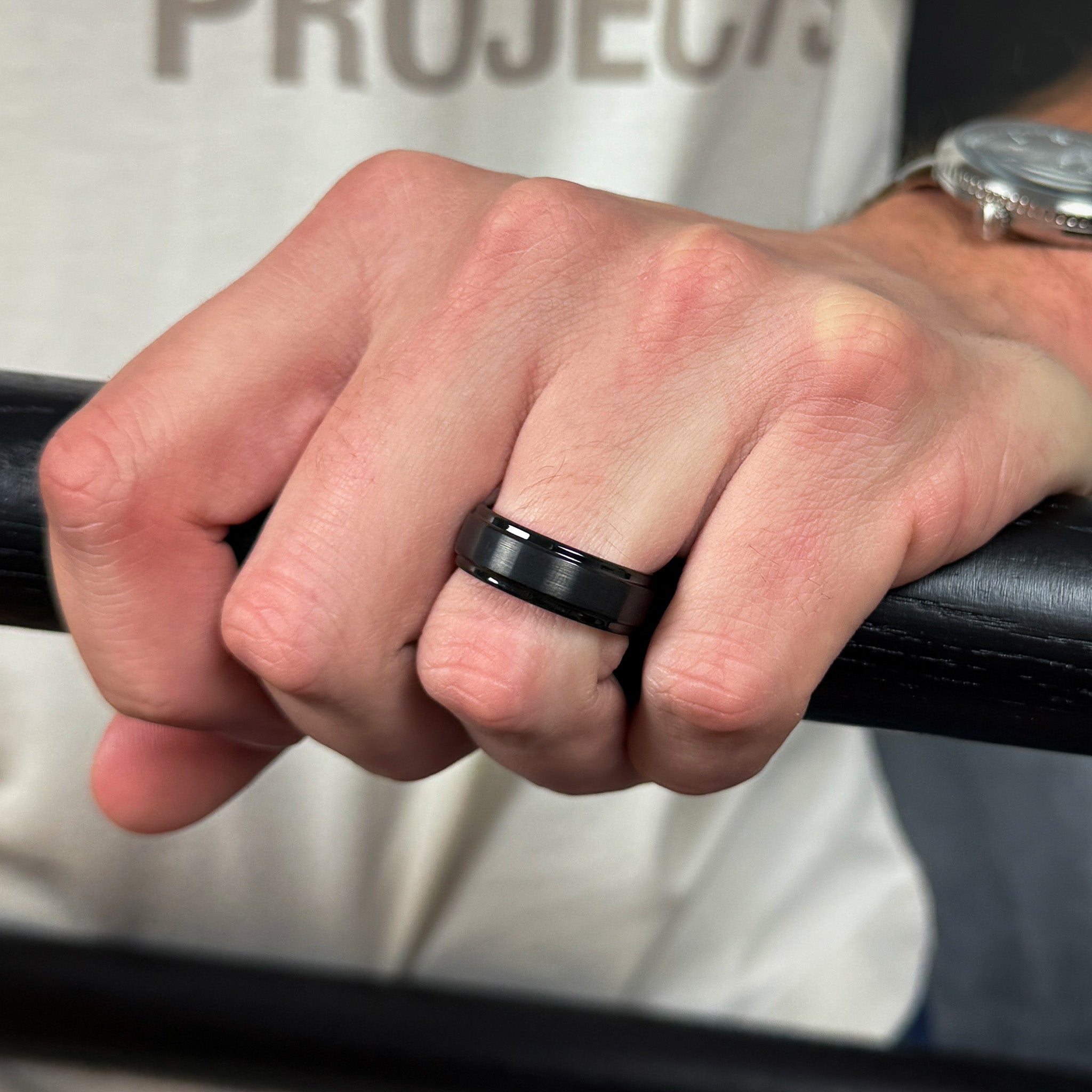 black brushed tungsten ring with a rose gold polished sleeve