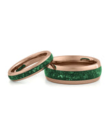 Matching rose gold wedding bands with green emerald stone inlays