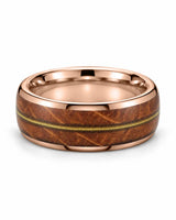 Rose gold guitar string wedding band lying flat, showing the wood inlay and polished interior