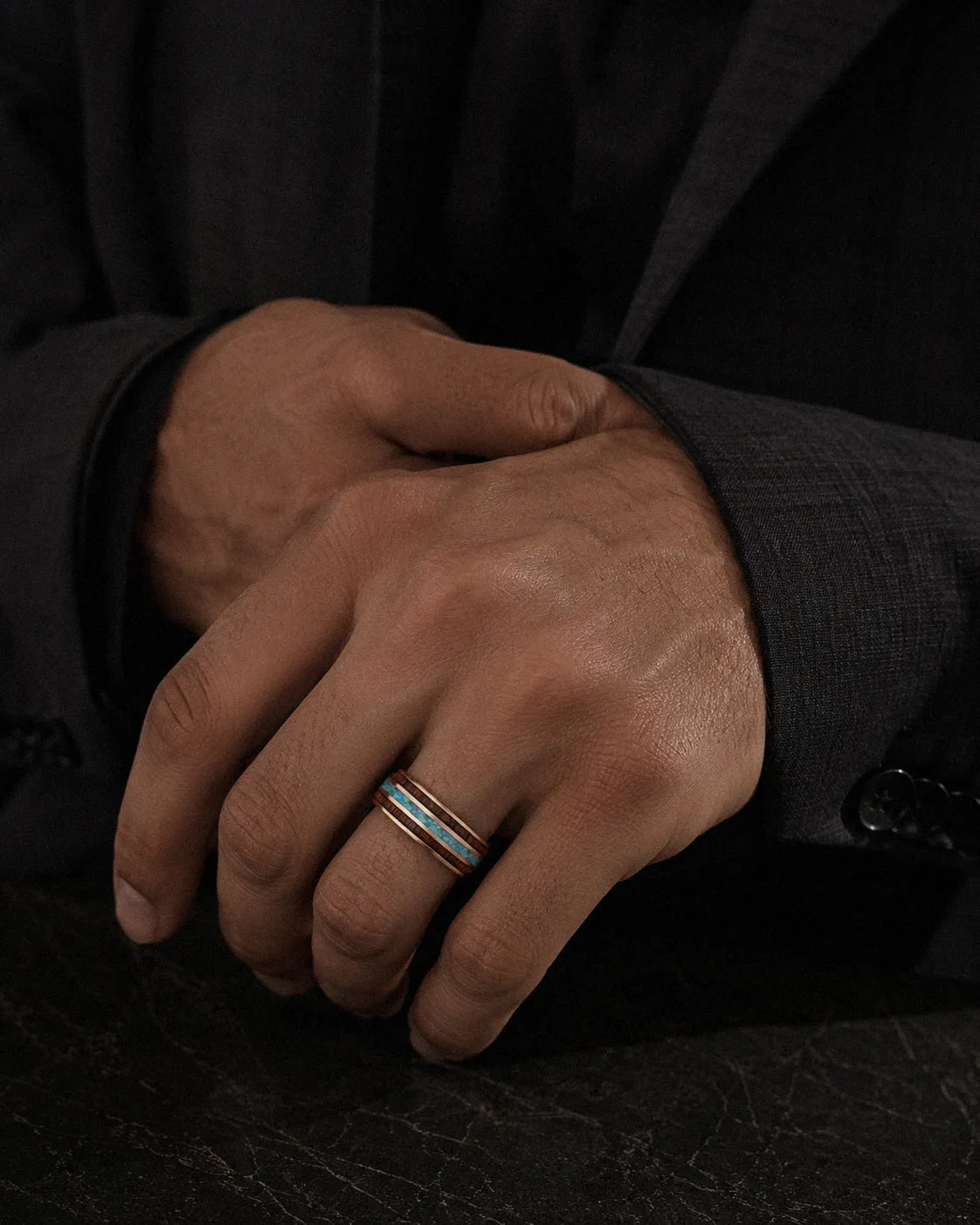 Man wearing a rose gold Koa wood and abalone shell tungsten ring
