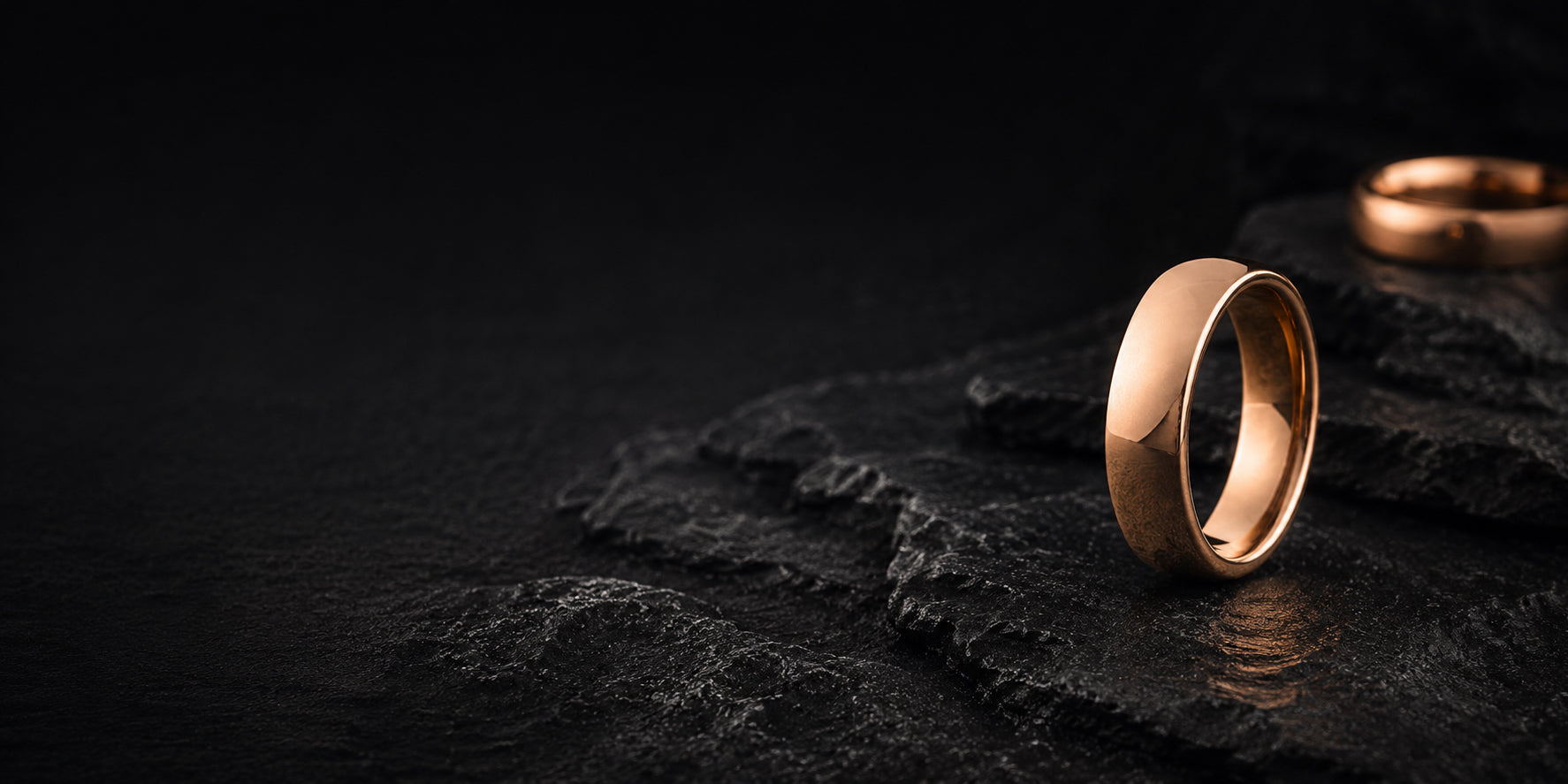 Rose gold men’s wedding band in a premium dark editorial hero banner setting with rugged slate textures