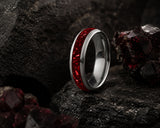 Ruby gemstone wedding ring collection hero image featuring a polished silver tungsten ring with vibrant red crushed ruby inlay on a dark luxury background.