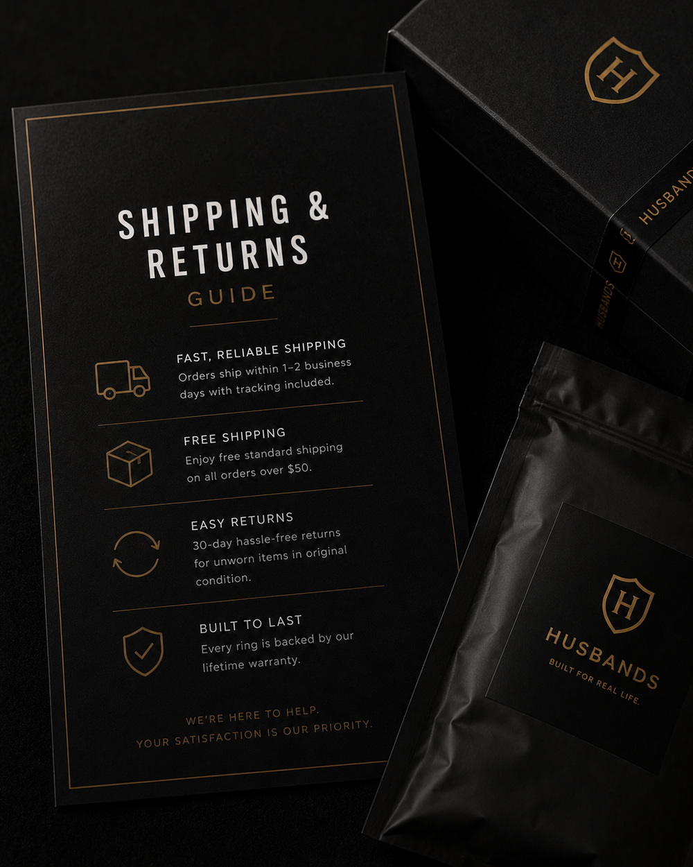 Black 'Husbands' packaging with shipping and returns guide on a dark background