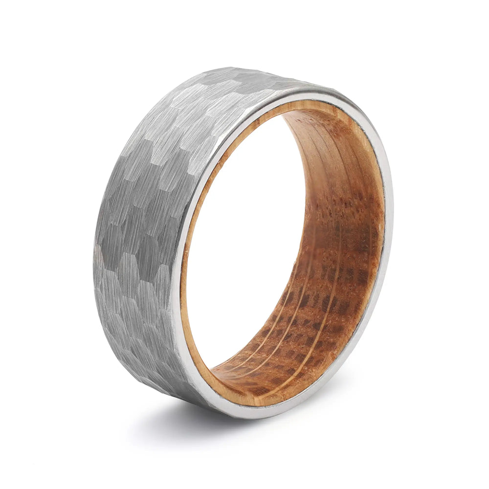 Silver hammered tungsten whiskey barrel wedding ring with a real oak wood interior.
