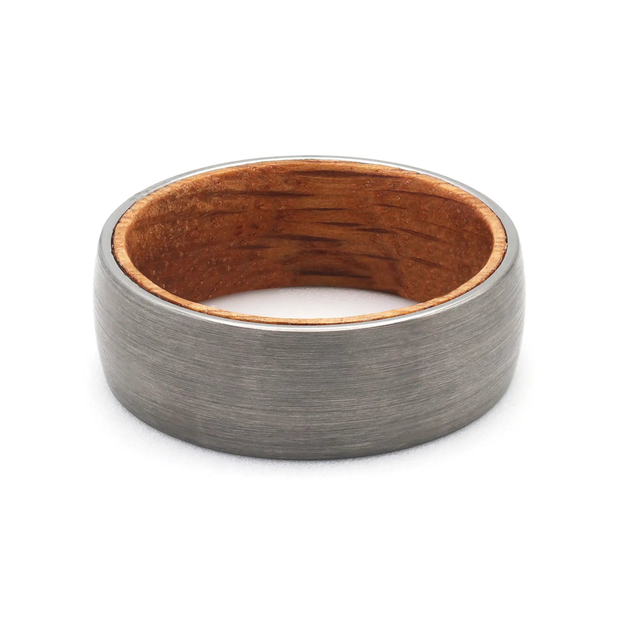 Top view of a silver tungsten wedding ring with a real oak whiskey barrel wood interior.