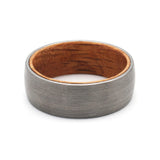 Top view of a silver tungsten wedding ring with a real oak whiskey barrel wood interior.