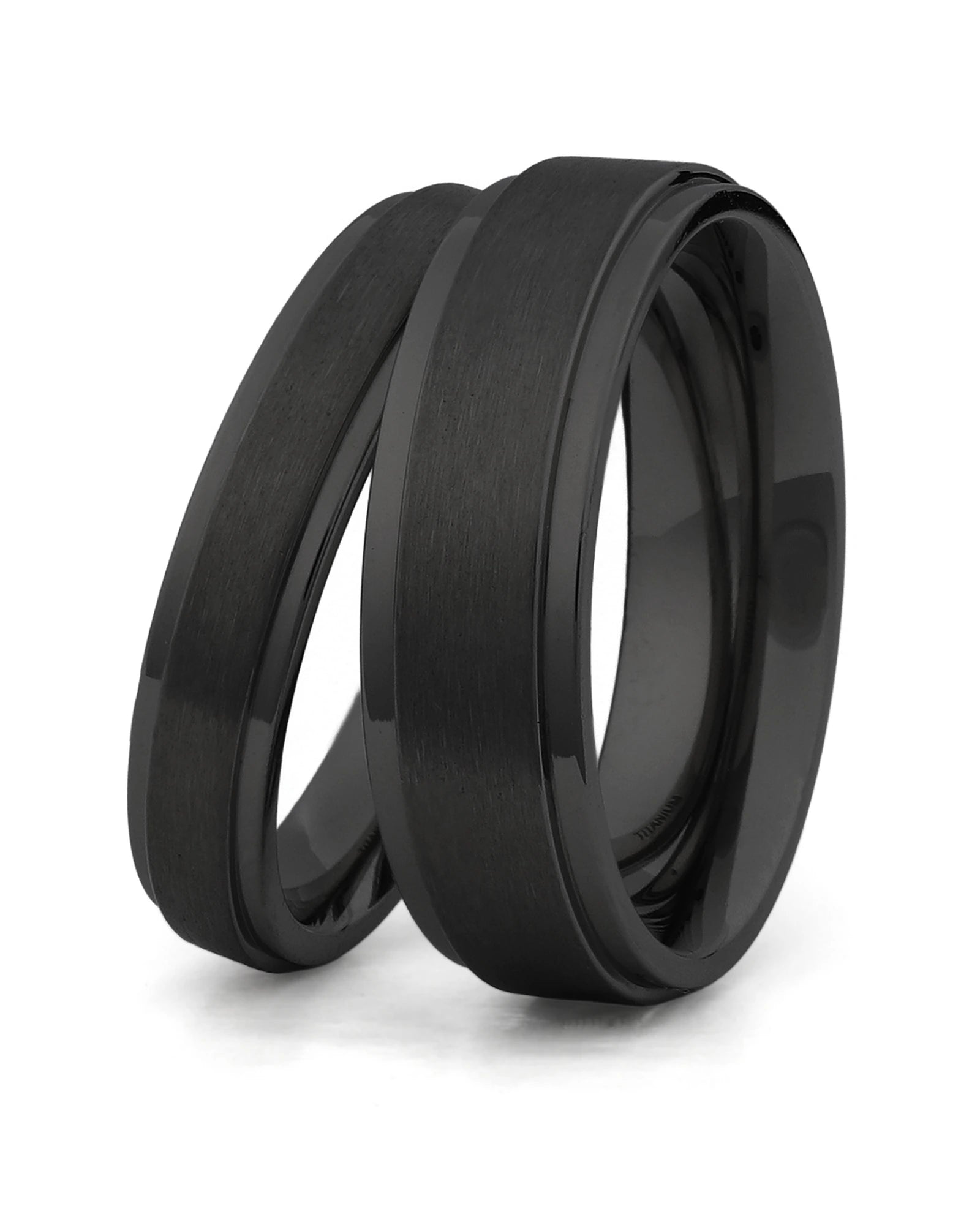 Matching black stepped titanium couples wedding rings shown together 