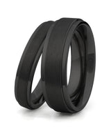 Matching black stepped titanium couples wedding rings shown together 