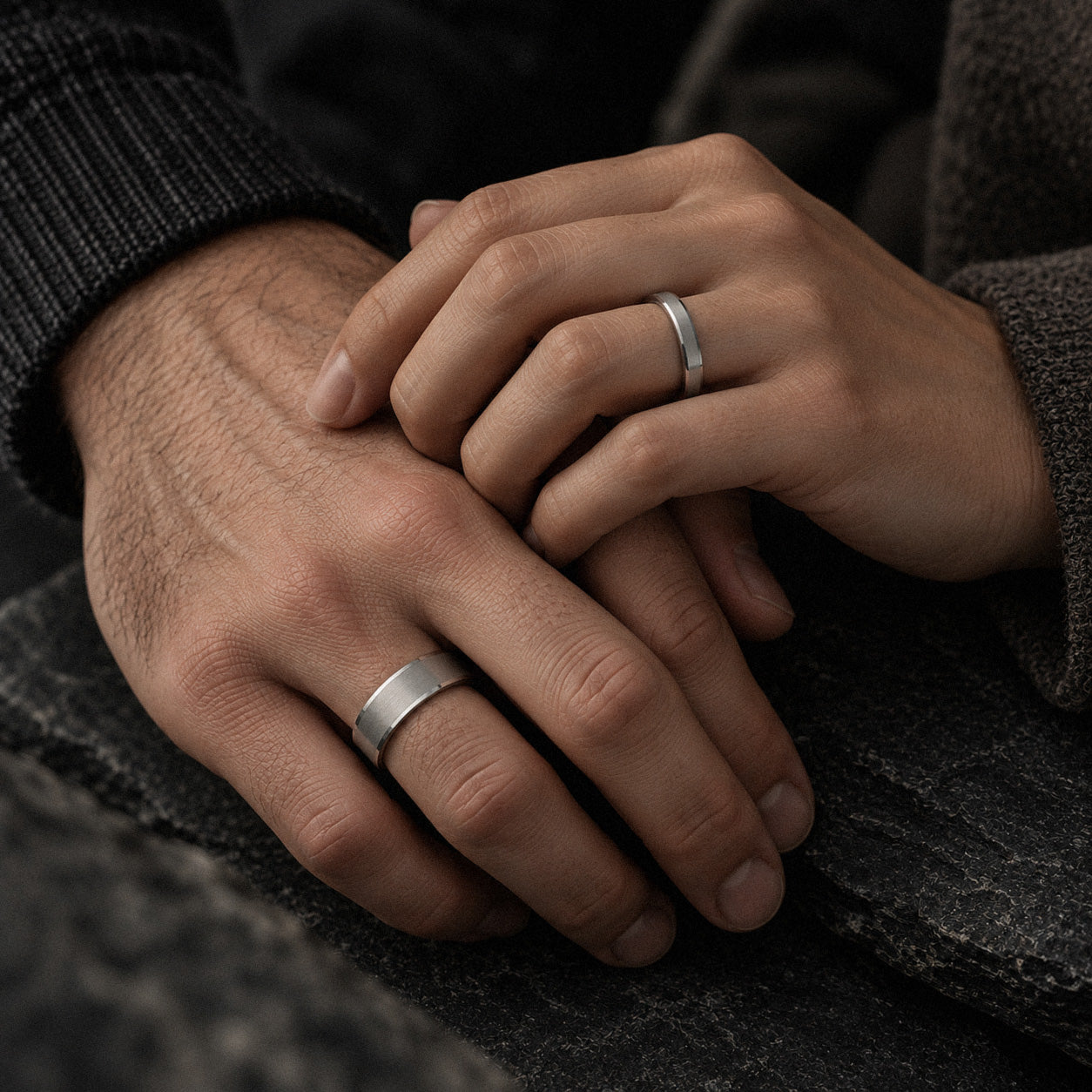 couple wearing matching titanium couples wedding ring set beveled brushed titanium bands