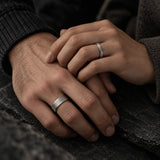 couple wearing matching titanium couples wedding ring set beveled brushed titanium bands