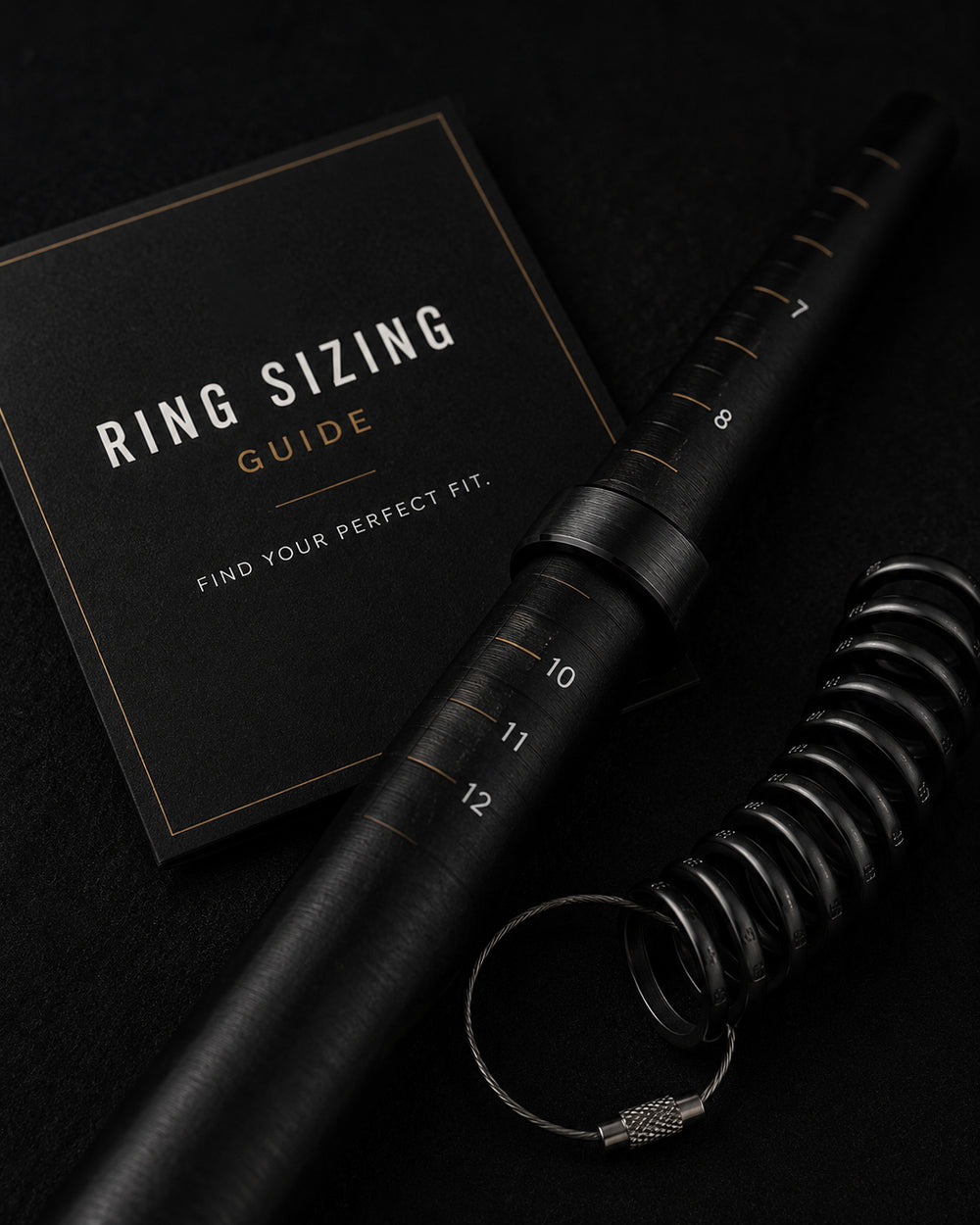 Ring sizer with ring and sizing guide on a dark background