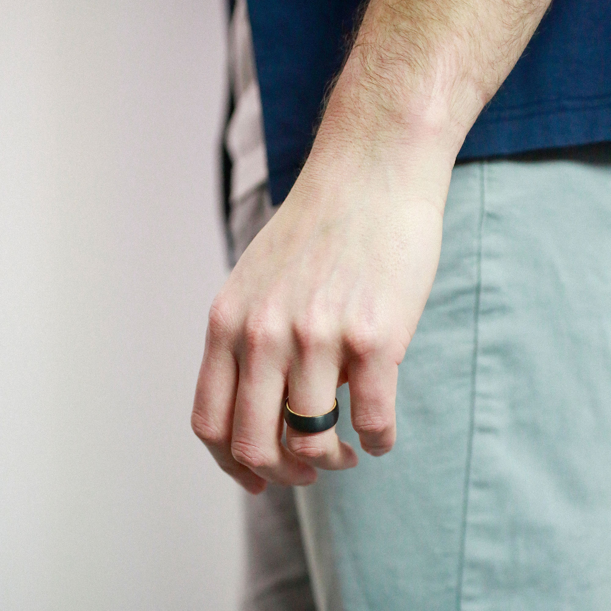 man wearing a tungsten wedding ring with whiskey wood sleeve