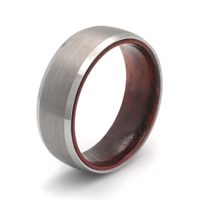 Silver tungsten whiskey barrel wood wedding ring photographed on a premium editorial light background.