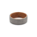 flat view of a mens brushed silver tungsten wedding ring with whiskey barrel wood sleeve