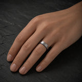 Woman wearing an 4mm brushed silver tungsten wedding ring with polished blue inner band