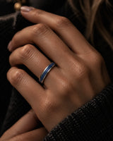 Woman wearing a 4mm silver wedding ring with blue sapphire inlay